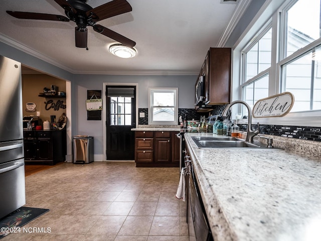 kitchen featuring crown molding, sink, light tile patterned flooring, dark brown cabinetry, and stainless steel refrigerator