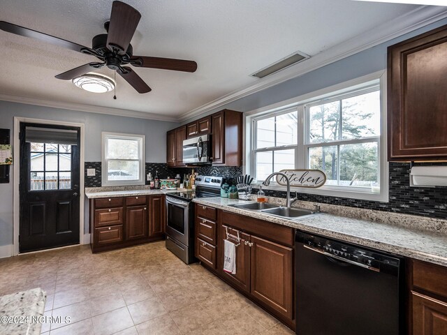 kitchen with a healthy amount of sunlight, sink, stainless steel appliances, and tasteful backsplash