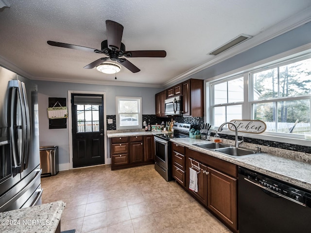 kitchen featuring appliances with stainless steel finishes, backsplash, crown molding, and sink