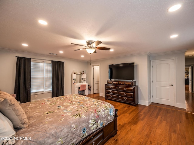 bedroom with a textured ceiling, dark hardwood / wood-style floors, ceiling fan, and crown molding