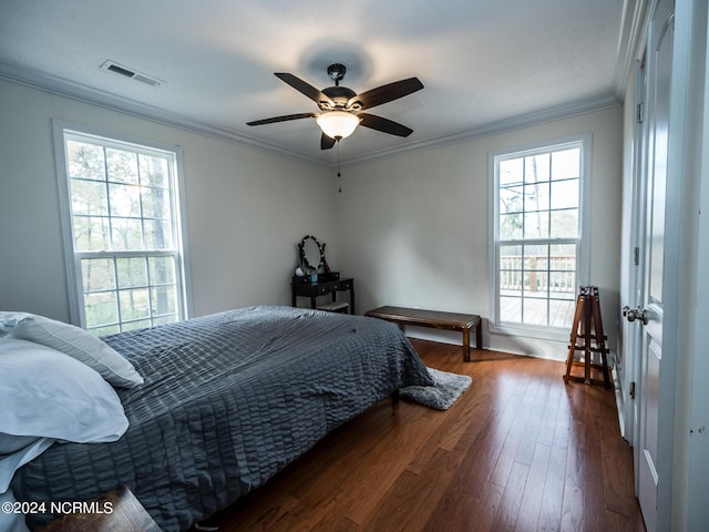 bedroom with ceiling fan, ornamental molding, dark wood-type flooring, and multiple windows