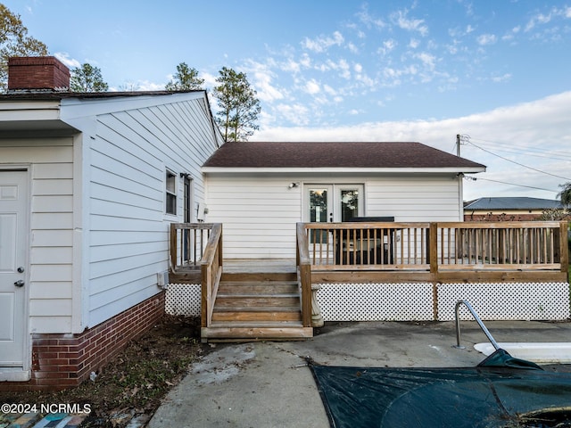 back of property featuring a wooden deck