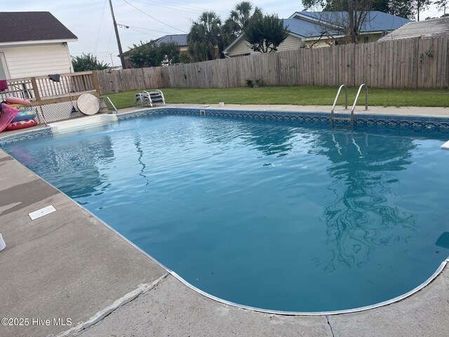 view of pool featuring a diving board and a deck