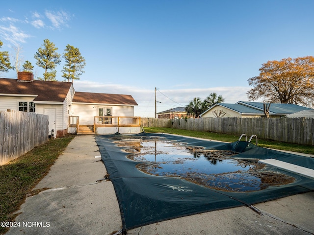 view of pool featuring a diving board and a deck