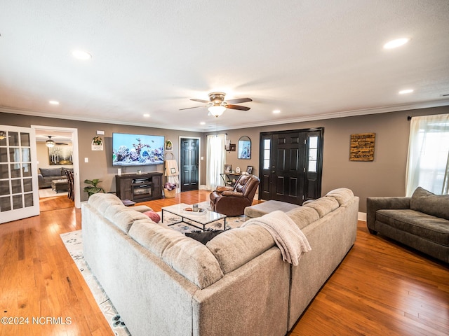 living room featuring crown molding, hardwood / wood-style floors, and ceiling fan