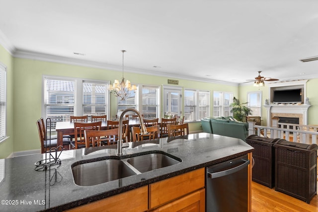 kitchen with a sink, dishwasher, ceiling fan with notable chandelier, open floor plan, and visible vents