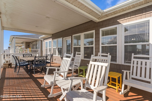 wooden terrace featuring outdoor dining area