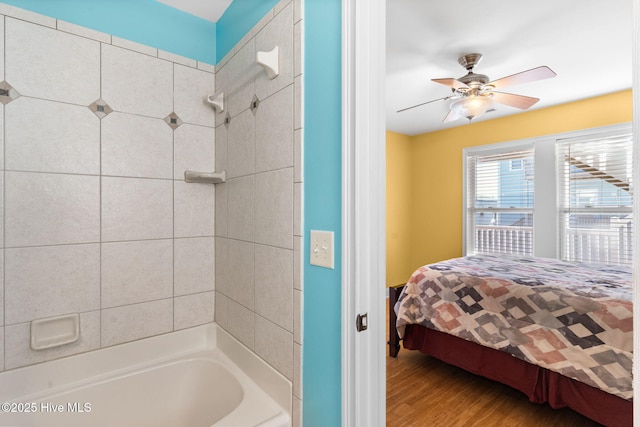 390 E Second St, Ocean Isle Beach, NC 28469 - bathroom featuring wood finished floors,  shower combination, ensuite bathroom, and a ceiling fan