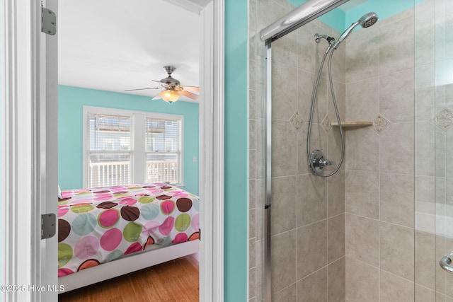 ensuite bathroom featuring connected bathroom, a ceiling fan, a shower stall, and wood finished floors