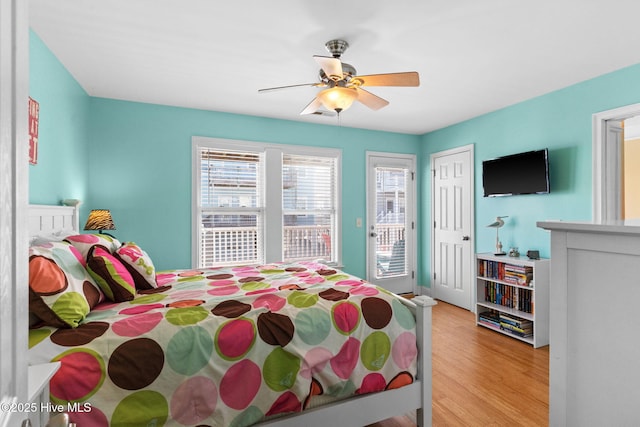 390 E Second St, Ocean Isle Beach, NC 28469 - bedroom featuring access to outside, light wood-type flooring, and a ceiling fan