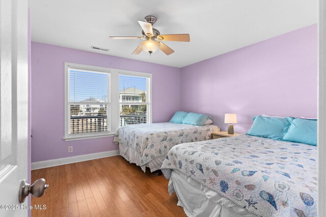 390 E Second St, Ocean Isle Beach, NC 28469 - bedroom with baseboards, wood finished floors, and ceiling fan