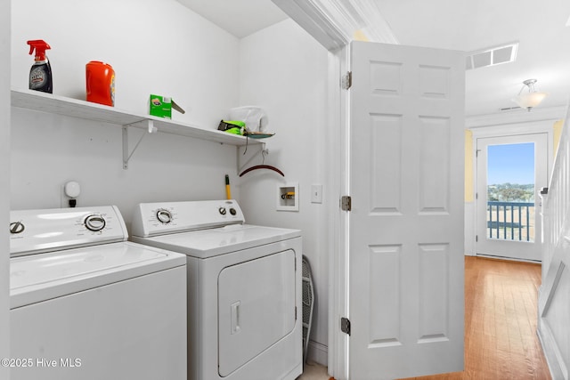 390 E Second St, Ocean Isle Beach, NC 28469 - laundry area featuring light wood finished floors and washer and dryer