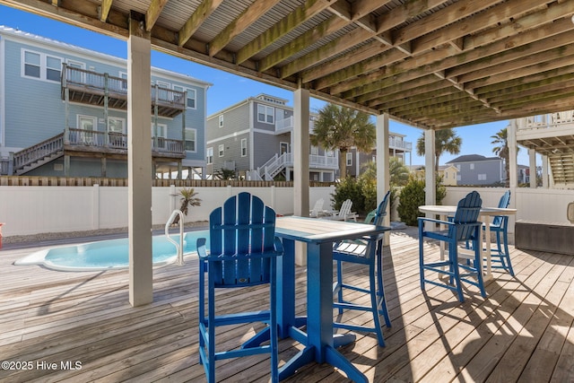 deck featuring a fenced in pool, a residential view, and a fenced backyard