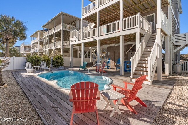 390 E Second St, Ocean Isle Beach, NC 28469 - view of swimming pool with stairs, a wooden deck, and a patio area