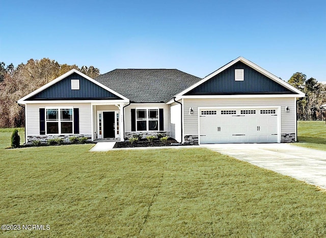 view of front of house featuring a garage and a front lawn