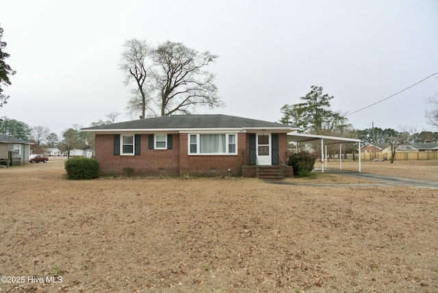 ranch-style house featuring a carport