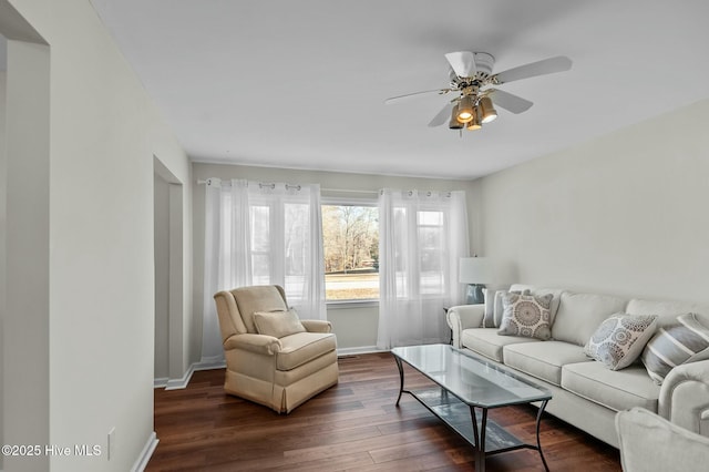 living room featuring ceiling fan and dark hardwood / wood-style floors