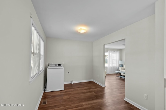 unfurnished room featuring washer / dryer and dark wood-type flooring