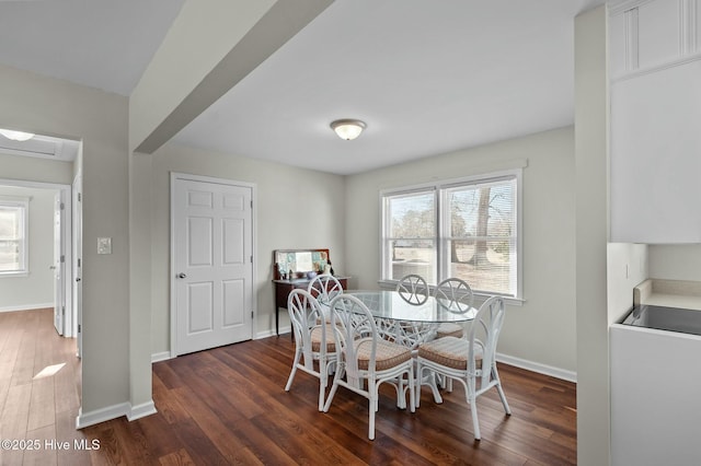 dining area with dark hardwood / wood-style floors