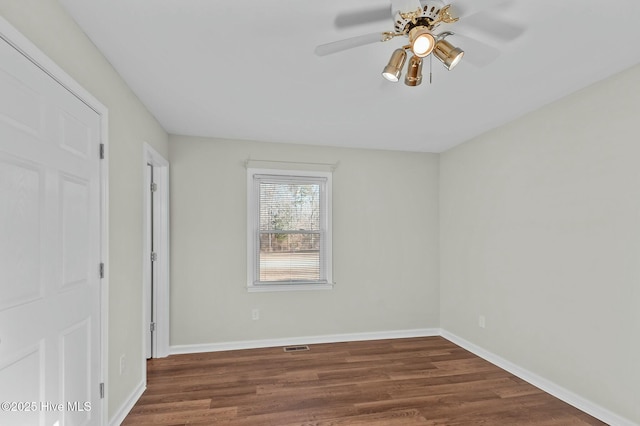 unfurnished bedroom with dark wood-type flooring and ceiling fan