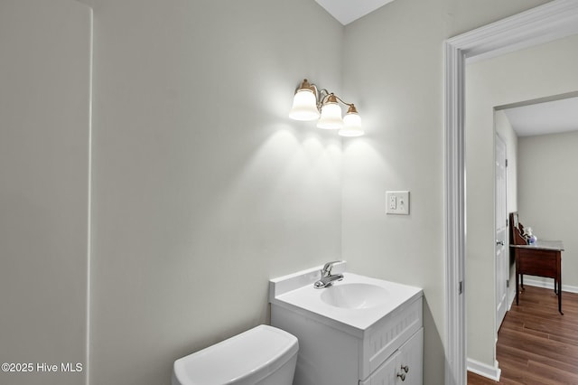 bathroom featuring vanity, toilet, and wood-type flooring