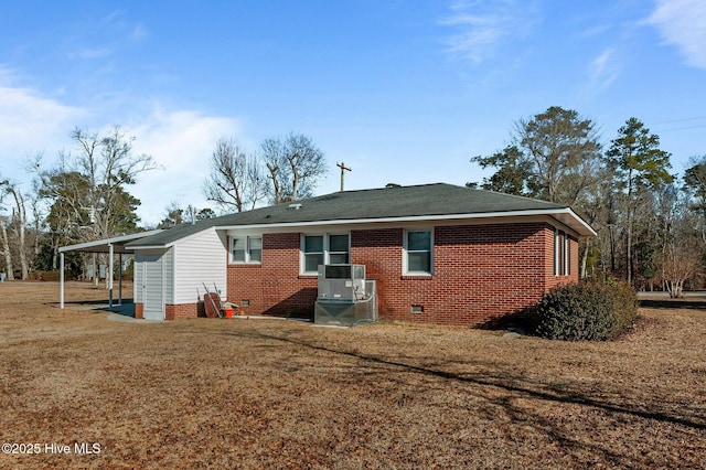 rear view of house with cooling unit and a lawn