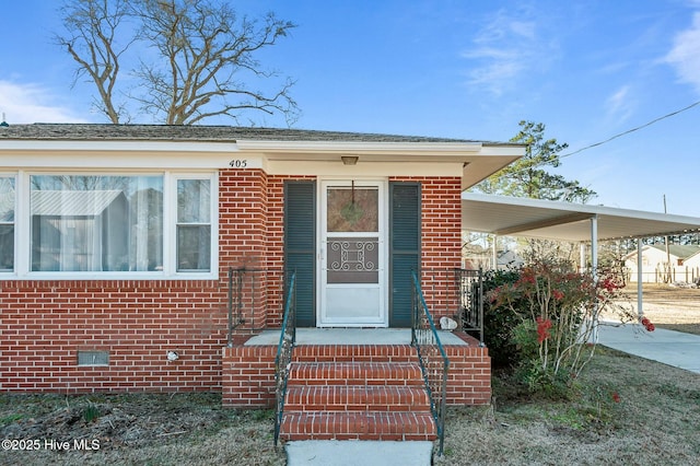 doorway to property with a carport