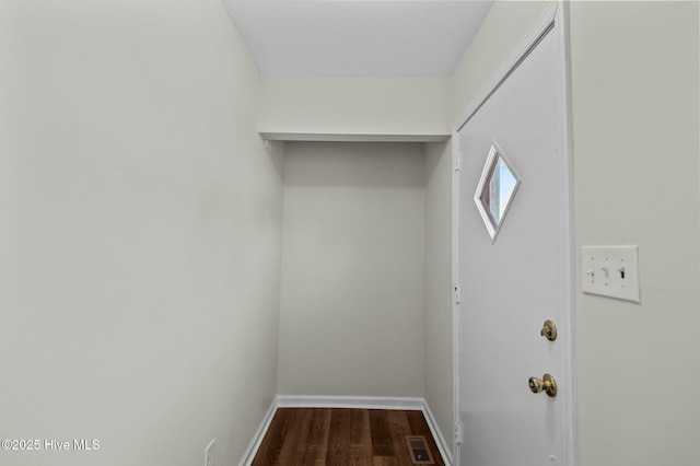 laundry area with dark hardwood / wood-style flooring