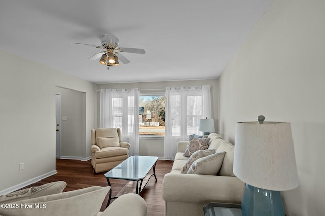 living room featuring ceiling fan and dark hardwood / wood-style floors