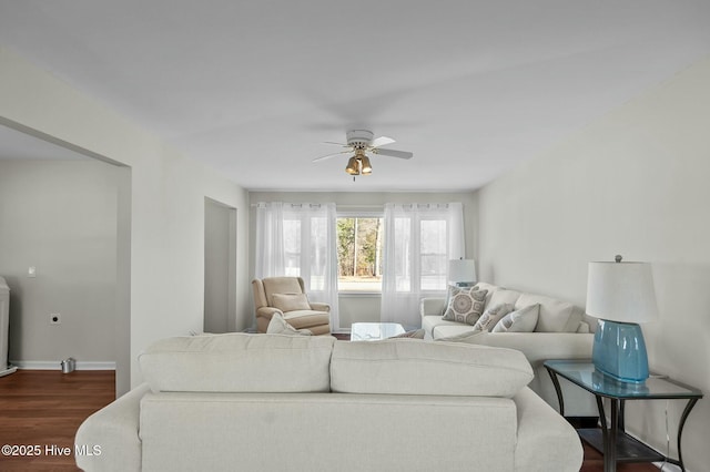 living room with dark hardwood / wood-style floors and ceiling fan