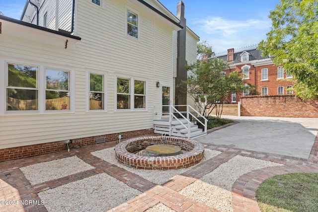 rear view of property with a patio, crawl space, and a chimney