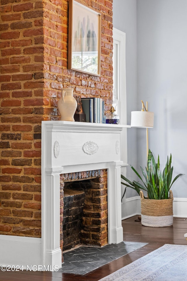 room details with a brick fireplace and hardwood / wood-style floors