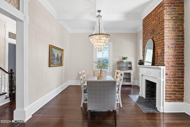 dining room with a large fireplace, crown molding, dark wood-type flooring, and an inviting chandelier