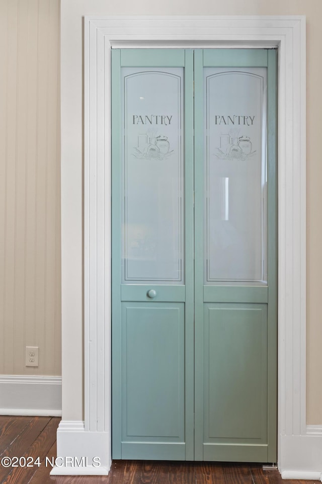 room details featuring baseboards and wood finished floors