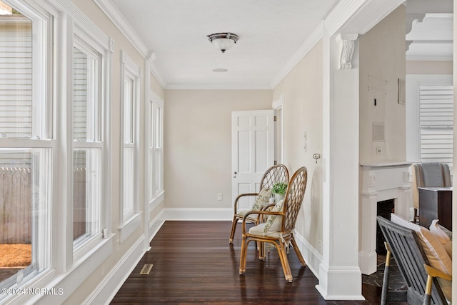 living area with dark wood-type flooring and crown molding