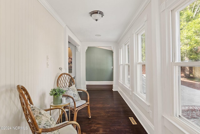 interior space with ornamental molding and dark hardwood / wood-style flooring