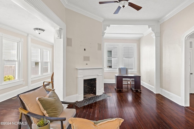 living area with hardwood / wood-style floors, crown molding, and a fireplace