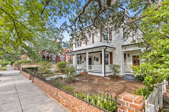 view of front facade featuring a fenced front yard and a porch