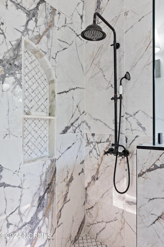 interior details featuring tiled shower