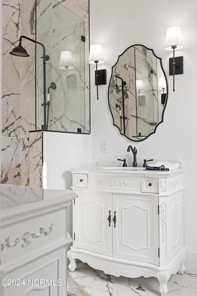 bathroom with vanity and a tile shower