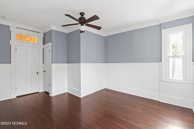 unfurnished room featuring crown molding, a ceiling fan, a wainscoted wall, and wood-type flooring