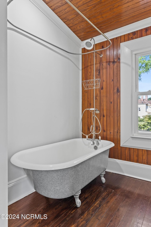 bathroom with a soaking tub, ornamental molding, wood ceiling, wood walls, and wood finished floors