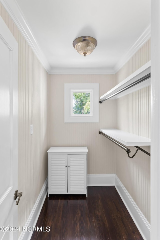 washroom featuring crown molding, dark wood-type flooring, and baseboards