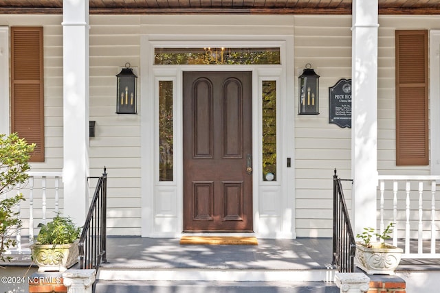 view of exterior entry featuring a porch