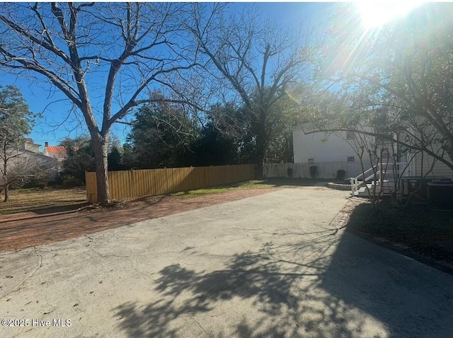 view of road featuring concrete driveway