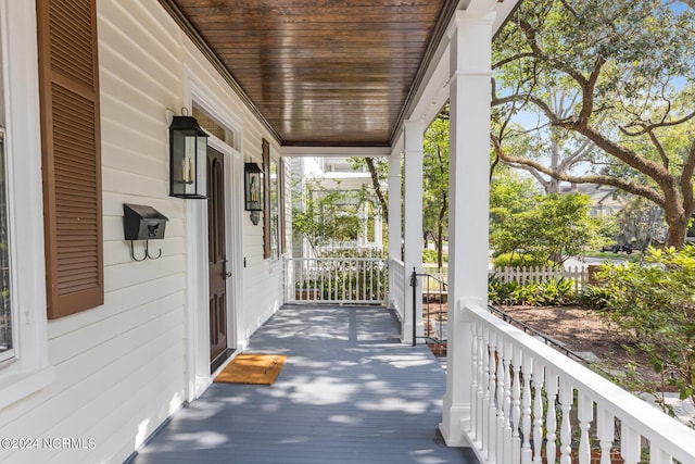 wooden terrace featuring covered porch