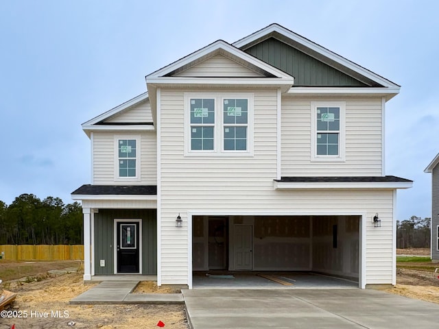 view of front of property featuring a garage, concrete driveway, and board and batten siding