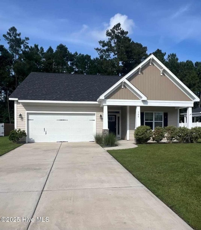 craftsman inspired home featuring a garage and a front lawn