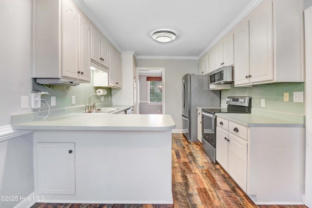 kitchen with kitchen peninsula, ornamental molding, stainless steel appliances, sink, and white cabinets