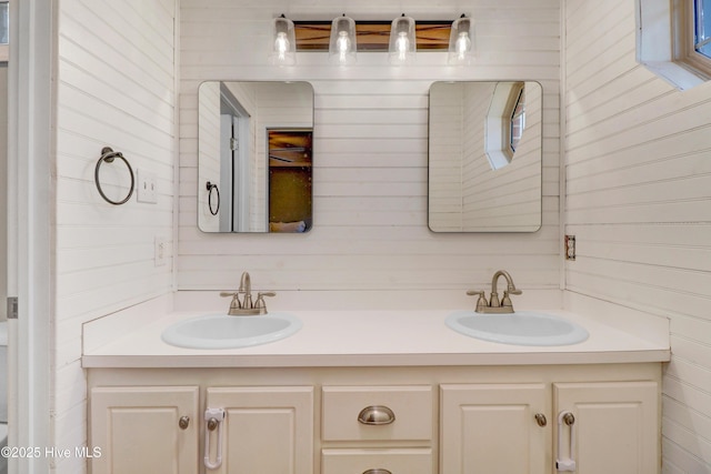 bathroom featuring wood walls and vanity